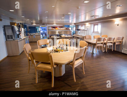 The dining area onboard a state-of-the-art Service Operation Vessel (SOV) that remains offshore with technicians working shifts of 14 days on and 14 days off at the Race Bank development, the fifth biggest wind farm in the world that has opened off the Norfolk and Lincolnshire coast with 91 huge turbines. Stock Photo