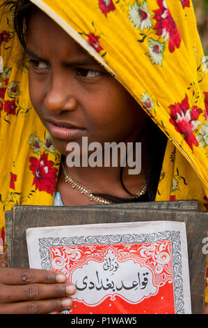 Portrait of a maktab student. Maktab an Arabic word meaning schools for teaching children in elementary Islamic subjects. Dhaka, Bangladesh. Stock Photo