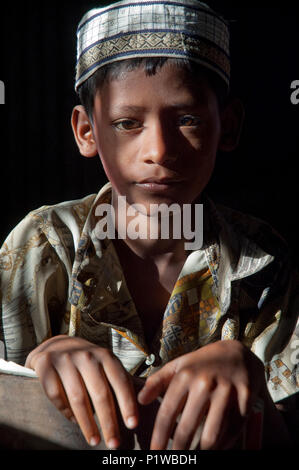 Portrait of a maktab student. Maktab an Arabic word meaning schools for teaching children in elementary Islamic subjects. Dhaka, Bangladesh. Stock Photo
