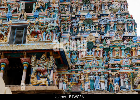 Painted statues on one of the gopura (towers) of Dravidian-style Kallalagar Temple, Madurai District, Tamil Nadu, India. Stock Photo