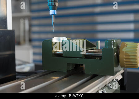 Processing of the plastic workpiece on CNC milling machine Stock Photo