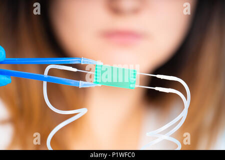 technician girl with microfluidic device LOC in microbiological lab Stock Photo