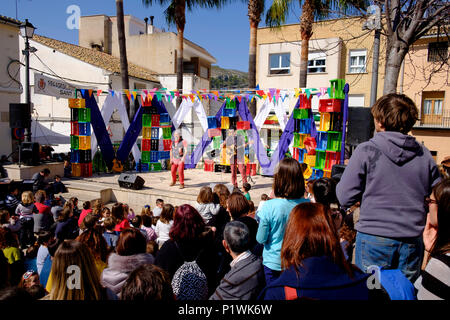 Two comedy entertainers on an outdoor stage watched by a crowd during a Spanish Fiesta Stock Photo