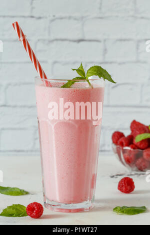 Raspberry milkshake with mint and drinking straws. Stock Photo