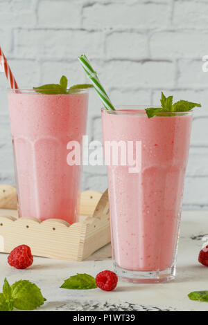 Raspberry milkshake with mint and drinking straws. Stock Photo