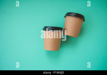 Two paper cups for hot drinks on blue background with text space. Stock Photo