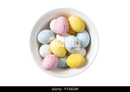 Season holidays concept. Colorful Easter eggs in a bowl, top view, cut out and isolated on white background Stock Photo