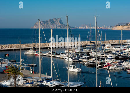 View of yachts and sailing boats in the marina port of Moraira, Calpe and Peñon de ifach in the background, Costa Blanca, Alicante province,Spain Stock Photo