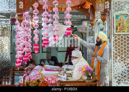 Manikaran, India - June 3, 2017: Sikh priest praying in Manikaran gurdwara in the Kullu District of Himachal Pradesh, India Stock Photo