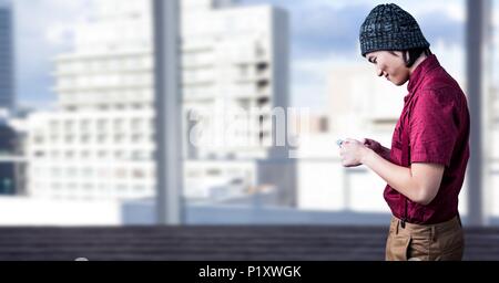 Man using phone with bright city background Stock Photo