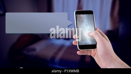 Messaging App on phone in hand with bedroom Stock Photo