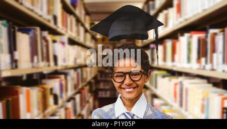 School boy in education library with graduation hat Stock Photo