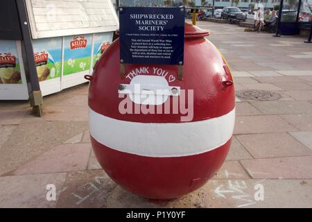 A World War 2 mine that has been converted into a collection box for Shipwrecked Mariners Society in Teignmouth, South Devon Stock Photo