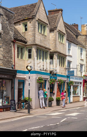 Attractive shops on Church Street, Tetbury, shoppers look in the windows, Gloucestershire, UK Stock Photo