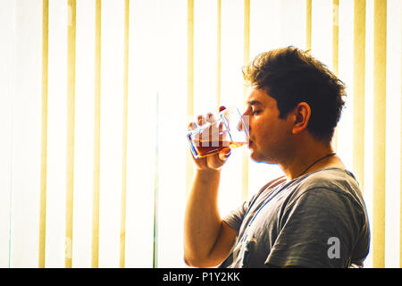 Young adult drinking whisky alcoholism concept man with drinking problems depression in young adults Stock Photo