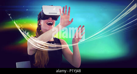 Female executive using virtual reality headset Stock Photo