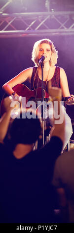 Female performer singing during music event Stock Photo