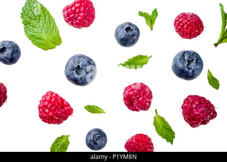 Creative layout, background, with fresh berries, simple pattern on white background. Raspberry, blueberry, mint leaves, slices of lemon. Stock Photo