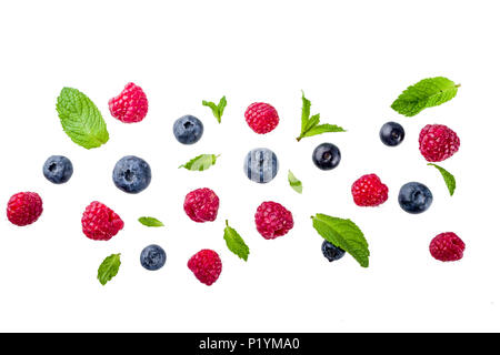 Creative layout, background, with fresh berries, simple pattern on white background. Raspberry, blueberry, mint leaves, slices of lemon. Stock Photo