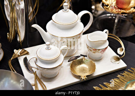 Tea service on a white table : Iron kettle, tea cup with hot tea, a soup  bowl & special spoon. Beautiful typical chinese restaurant Stock Photo -  Alamy