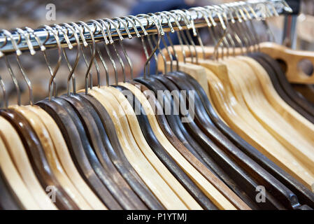 Empty wooden hangers in the store Stock Photo