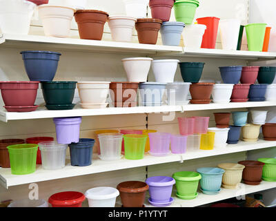 Colored plastic flower pots on the counter in the store Stock Photo