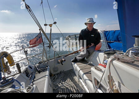 Lone man sailing boat on north sea Stock Photo