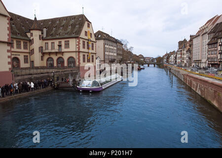 STRASBOURG, FRANCE - DECEMBER 11, 2011: people on waterfront of Ill river canal in old Strasbourg town. The historic city centre Grand Island was classified a World Heritage site by UNESCO in 1988 Stock Photo