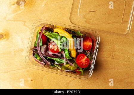 Vegetable salad in a plastic box with plastic fork Stock Photo