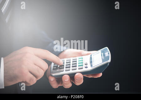 Closeup image of a business man using calculator Stock Photo