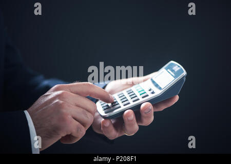 Closeup image of a business man using calculator Stock Photo