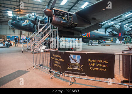 Avro Lancaster NX611 Just Jane in her hangar at the Lincolnshire Aviation Heritage Centre  East Kirkby. She is slowly being made airworthy. Stock Photo