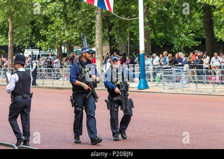 Armed Police officers of The Specialist Firearms Command SCO19  patrolling the crowds at The Trooping Of The Colour Ceremony, The Mall, London, UK Stock Photo