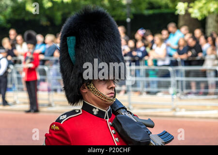 A soldier of The Irish Guards marching along the Mall at The Trooping Of The Colour or Queen's Birthday Parade, London, UK Stock Photo