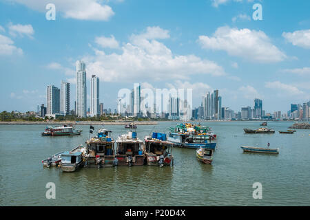 Panam City, Panama - march 2018: Fishing boats at commercial fish market harbour with skyline background Stock Photo