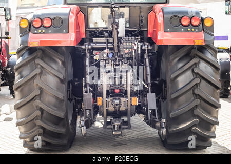 Red tractor with bif black wheels. rear view Stock Photo