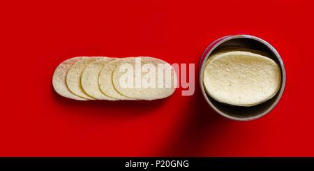 Close up of stacked potato chips - isolated on red background. Stock Photo
