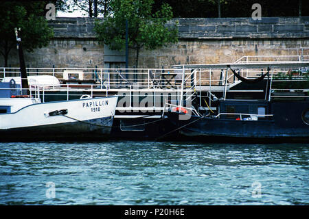 House boats parked several deep along the banks of the Siene River in Paris. Stock Photo