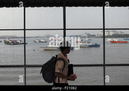 Klang, Selangor, Malaysia. 13th June, 2018. A boy walking toward his ferry departing to Tanjung Balai from Port Klang ferry terminal. Thousand of Indonesian who work and live in Malaysia were expected to return home through Tanjung Balai, ahead of Eid al-Fitr celebration on June 15, 2018. Credit: Aizzat Nordin/SOPA Images/ZUMA Wire/Alamy Live News Stock Photo
