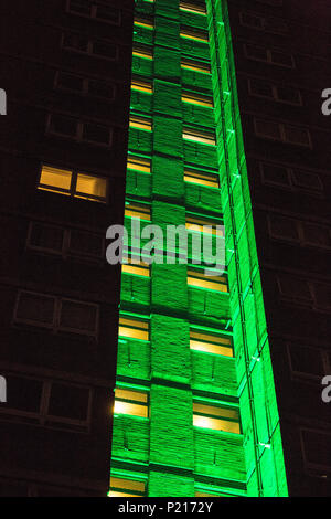 London, UK. 14th June, 2018. The Green for Grenfell illuminations are lit at the Grenfell Tower and the twelve closest tower blocks (seen here Dixon House on the Silchester West Estate) on the first anniversary of the fire in a display intended to 'shine a light' of love and solidarity for all those affected and to raise awareness of the plight of those still without new homes after one year. Green for Grenfell is a community-led initiative in collaboration with tenants' and residents' associations and Grenfell United. Credit: Mark Kerrison/Alamy Live News Stock Photo
