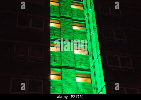 London, UK. 14th June, 2018. The Green for Grenfell illuminations are lit at the Grenfell Tower and the twelve closest tower blocks (seen here Dixon House on the Silchester West Estate) on the first anniversary of the fire in a display intended to 'shine a light' of love and solidarity for all those affected and to raise awareness of the plight of those still without new homes after one year. Green for Grenfell is a community-led initiative in collaboration with tenants' and residents' associations and Grenfell United. Credit: Mark Kerrison/Alamy Live News Stock Photo