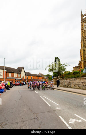 Day two of the Grand Depart from Rushden, Northamptonshire of the OVO Energy Women's Cycle Tour 2018. The cyclists race past the iconic St Mary's Church on the High Street in Rushden, Northamptonshire. Credit: GLC Pix/Alamy Live News Rushden, UK. 14th June 2018. Stock Photo