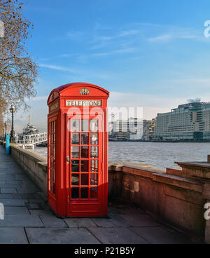 Classic British red telephone box at Thames embankment in London center. Stock Photo