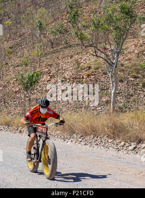 Gibb Challenge 2018 cyclist riding a fatbike on a dirt road El Questro Station Kimberley Western Australia Stock Photo