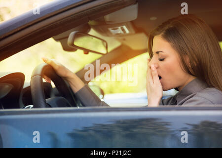 attention tired woman driving a car Stock Photo - Alamy