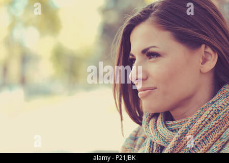 Closeup of a beautiful happy woman on a outdoors city street background Stock Photo