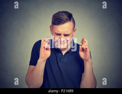 man making a wish keeping his fingers crossed. Stock Photo