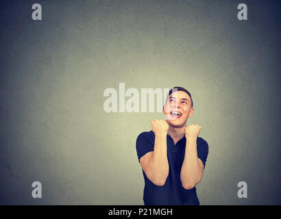Happy successful man winning, fists pumped celebrating success. Stock Photo
