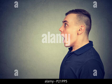 Shocked dazed young man isolated on gray background Stock Photo
