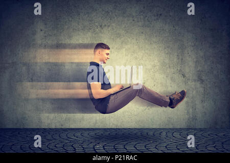 Fast internet concept. Levitating business man on road using laptop Stock Photo